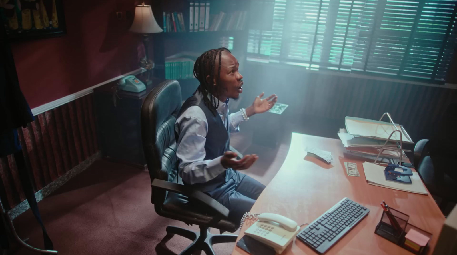 a man sitting at a desk in front of a computer