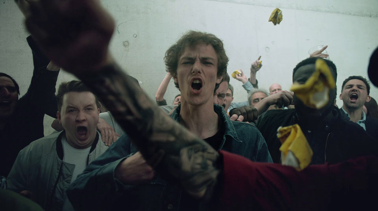 a group of people in a room with one holding a banana