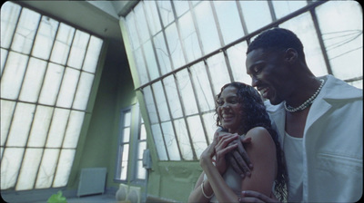 a man and a woman standing in front of a window