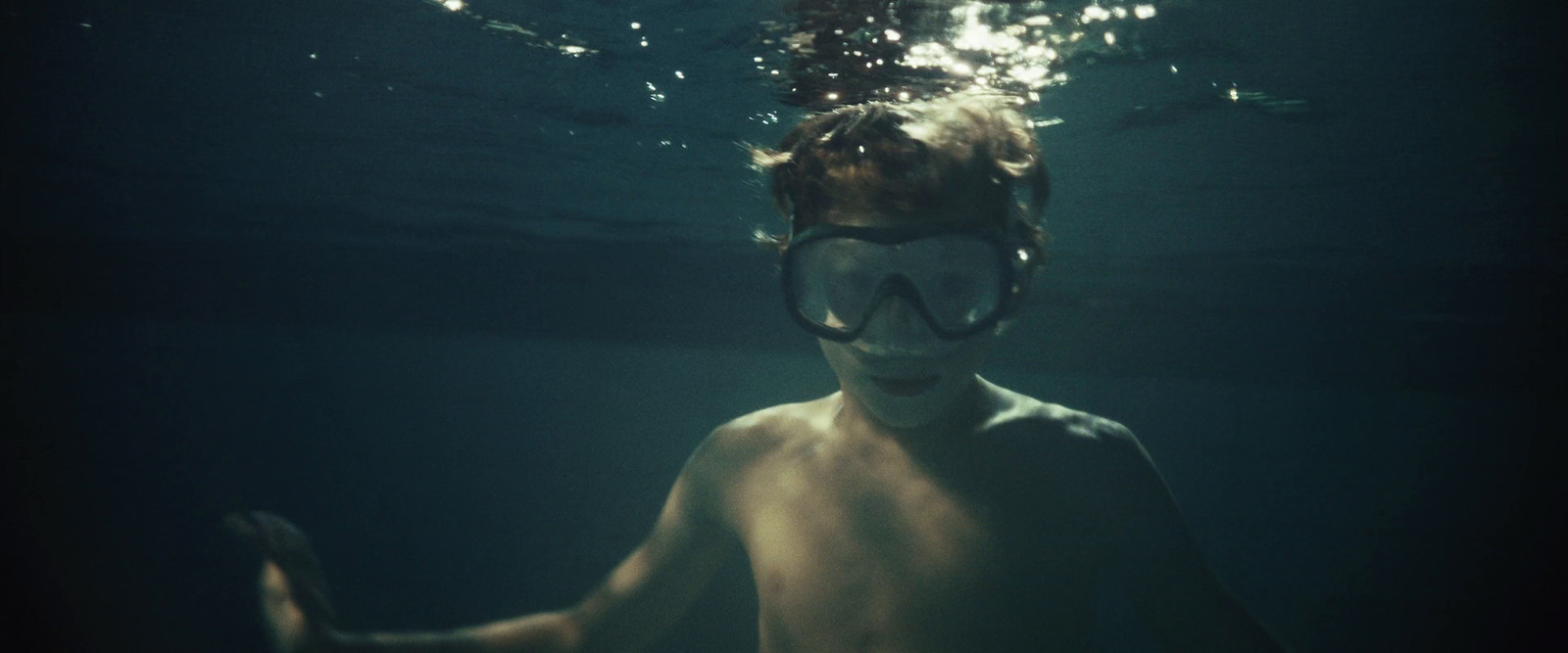 a man with a mask and goggles under water