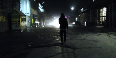 a person walking down a street at night