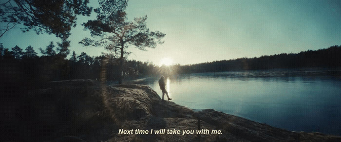 a person standing on a beach next to a body of water