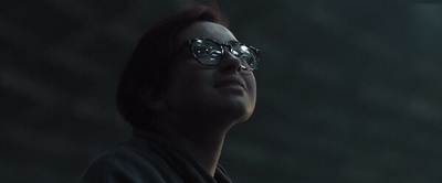 a woman wearing sunglasses looking up into the sky