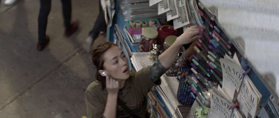 a woman reading a newspaper in a store