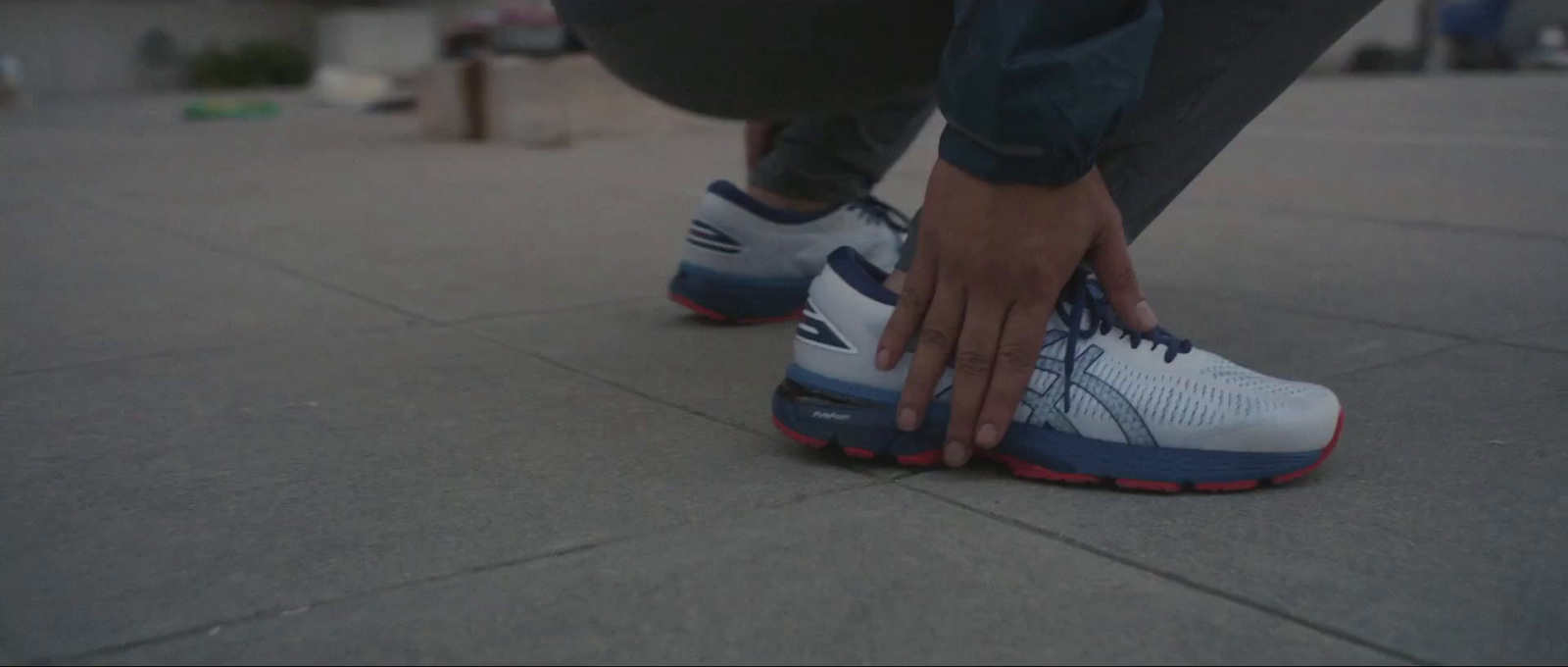 a close up of a person tying their shoes