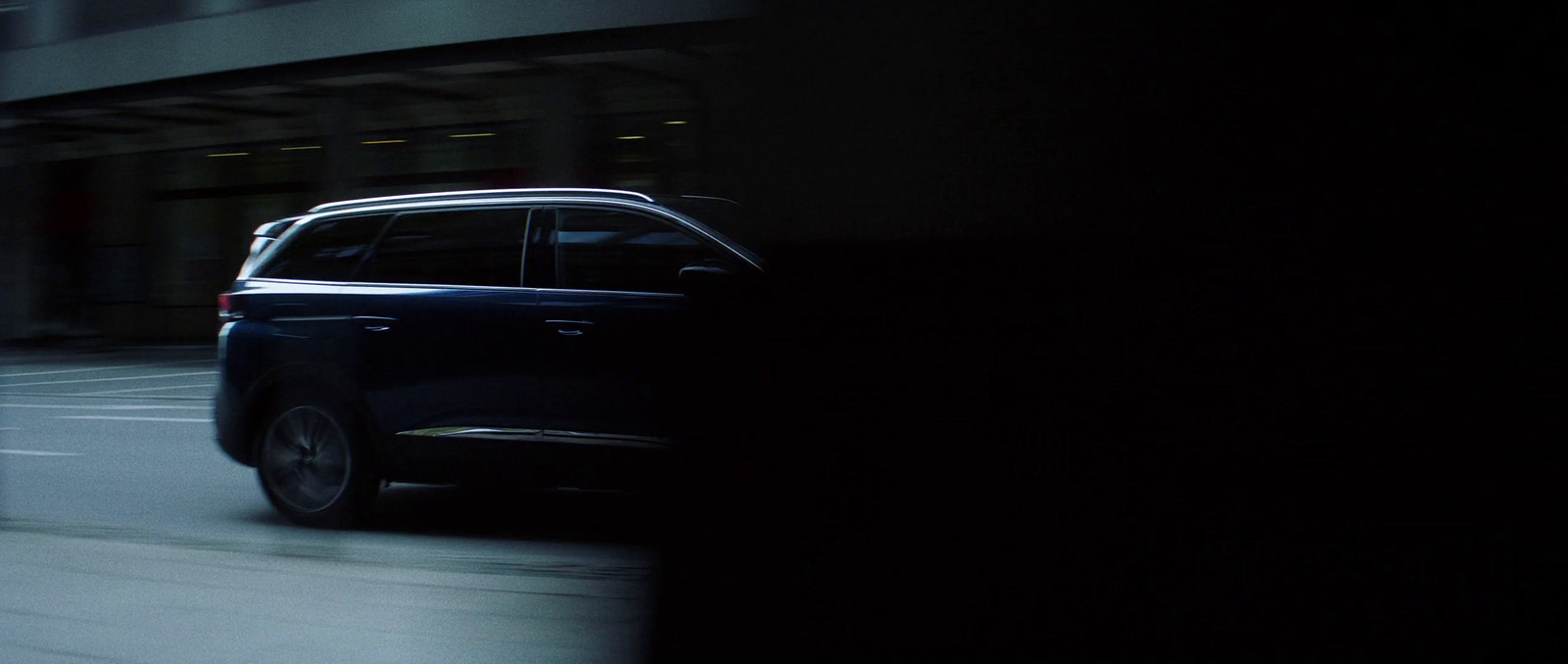 a car driving down a city street at night