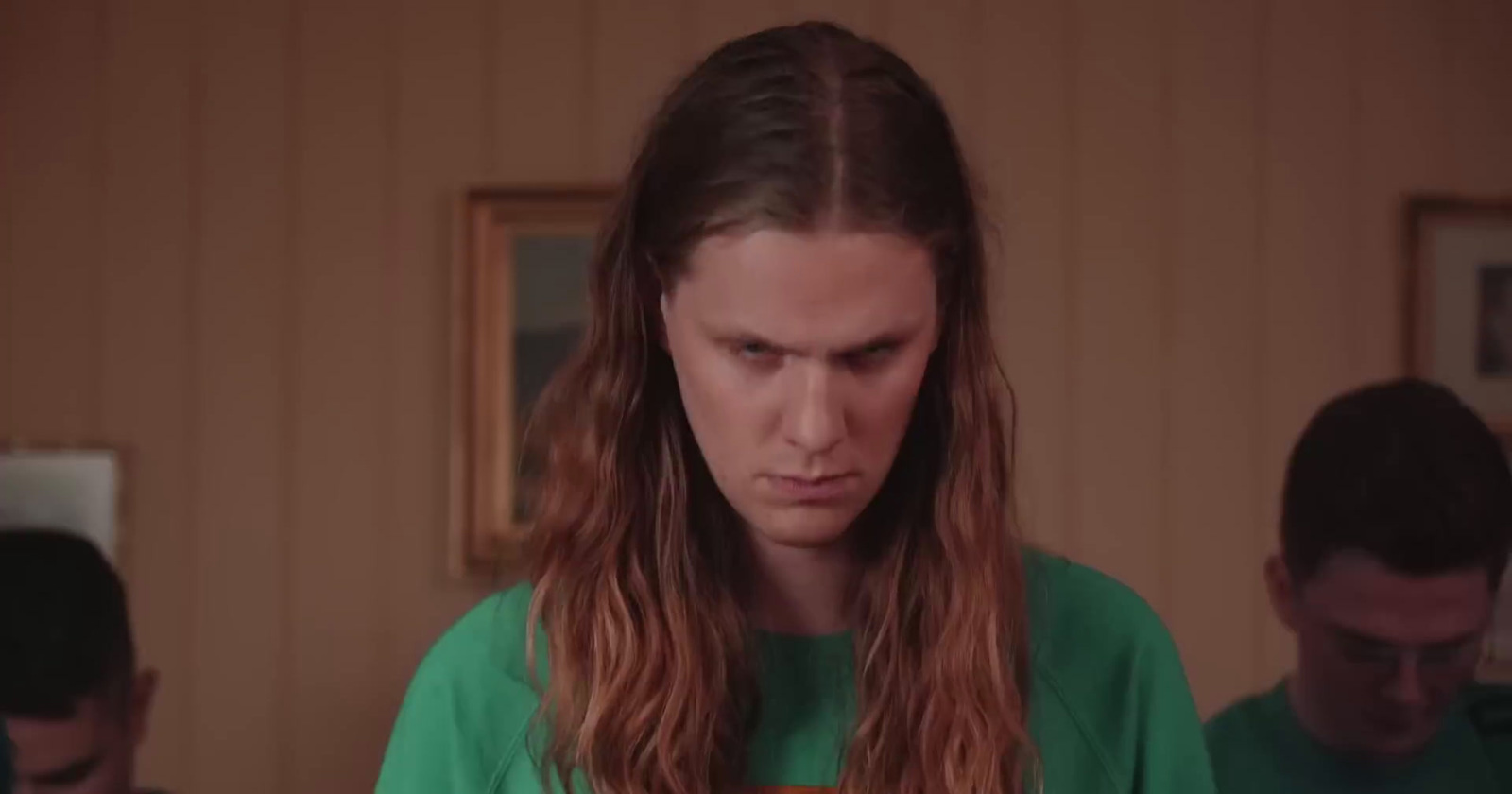 a woman with long hair standing in a room