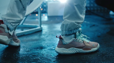 a person in white pants and sneakers standing on a wet surface