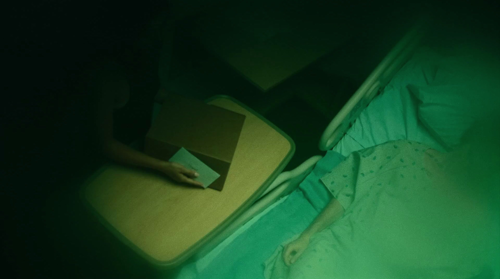 a person laying in a bed with a suitcase