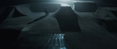 a person standing in a dark room with a skateboard