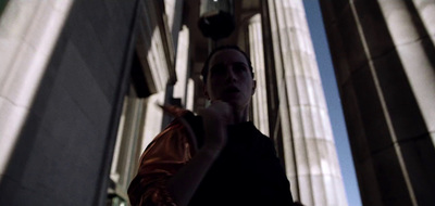 a woman standing in front of a tall building