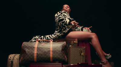 a woman sitting on top of a pile of luggage