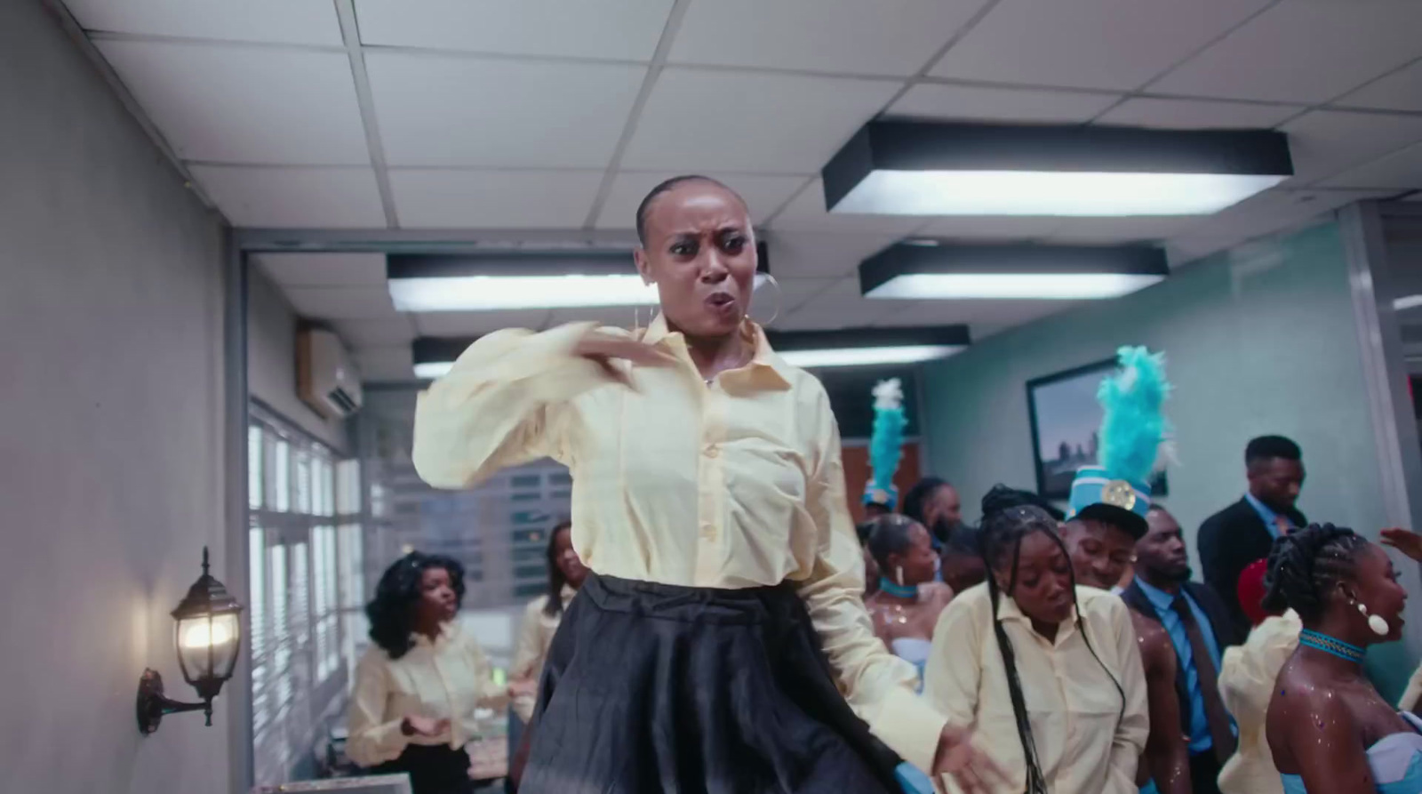 a woman in a white shirt and black skirt standing in front of a group of