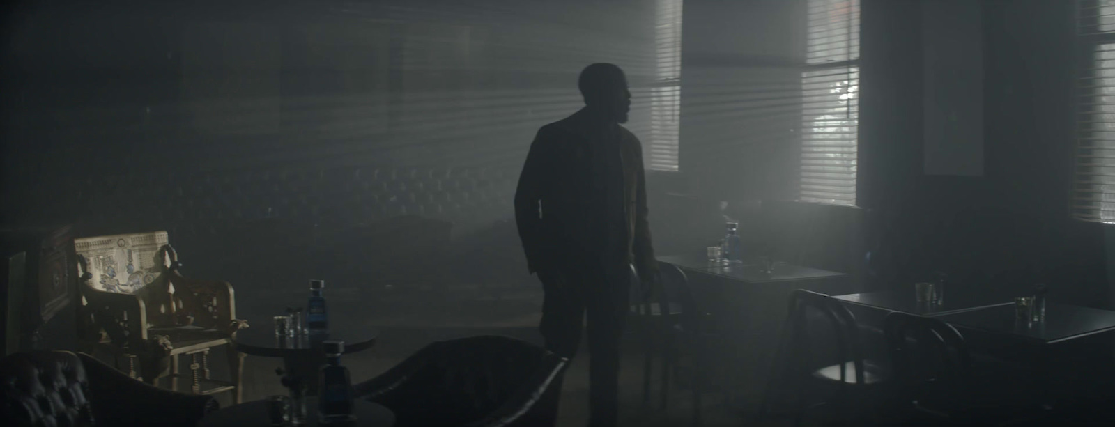 a man standing in a dark room in the dark