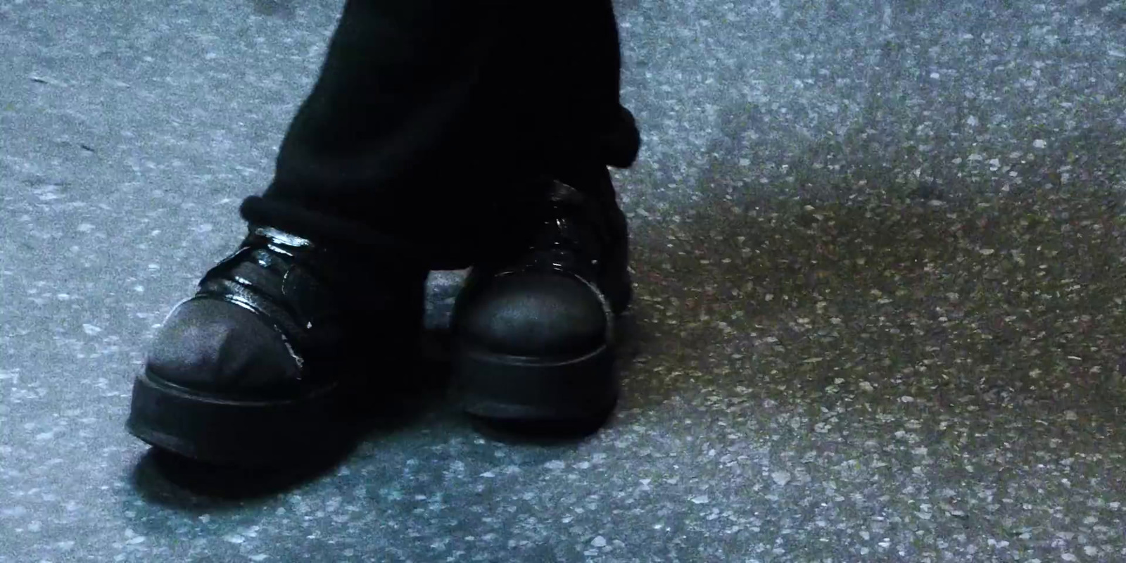 a close up of a person wearing black shoes