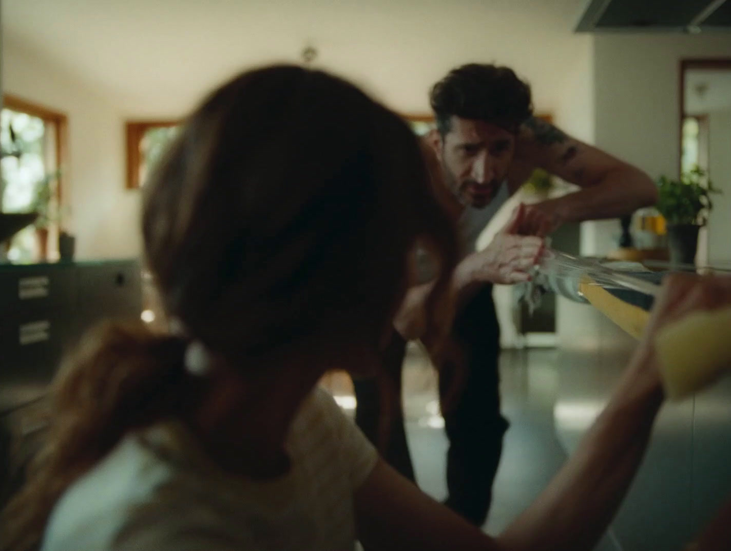 a man and a woman standing in a kitchen