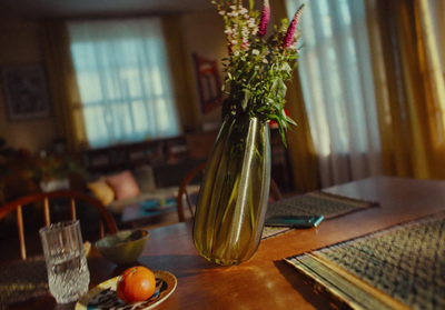 a table with a vase of flowers on top of it