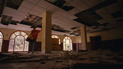 a person standing in a room with a broken ceiling