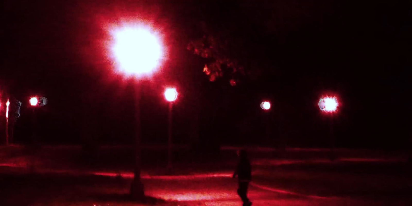 a person walking down a street at night