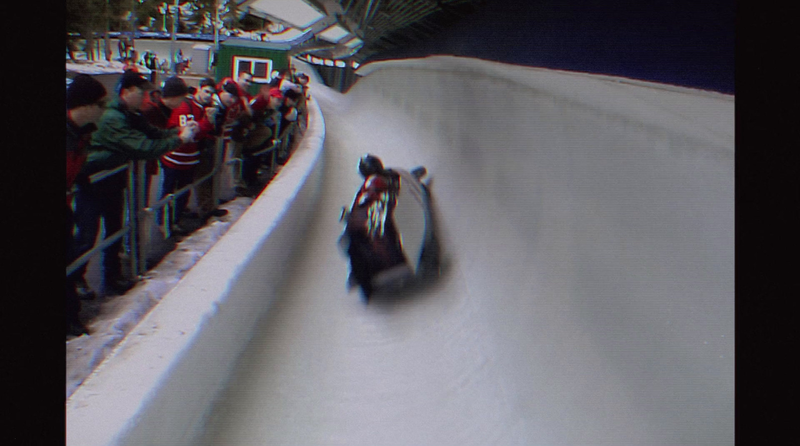 a person riding a snowmobile down a snow covered slope