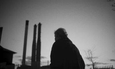 a man is standing in front of a factory