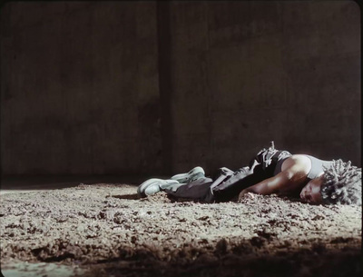 a man laying on the ground in the dirt