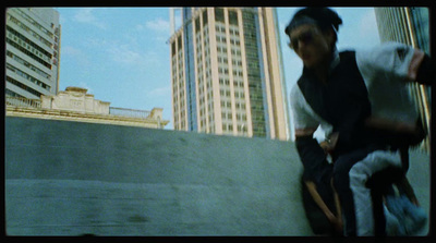 a man riding a skateboard down the side of a cement wall