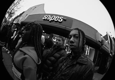 a group of people standing in front of a store