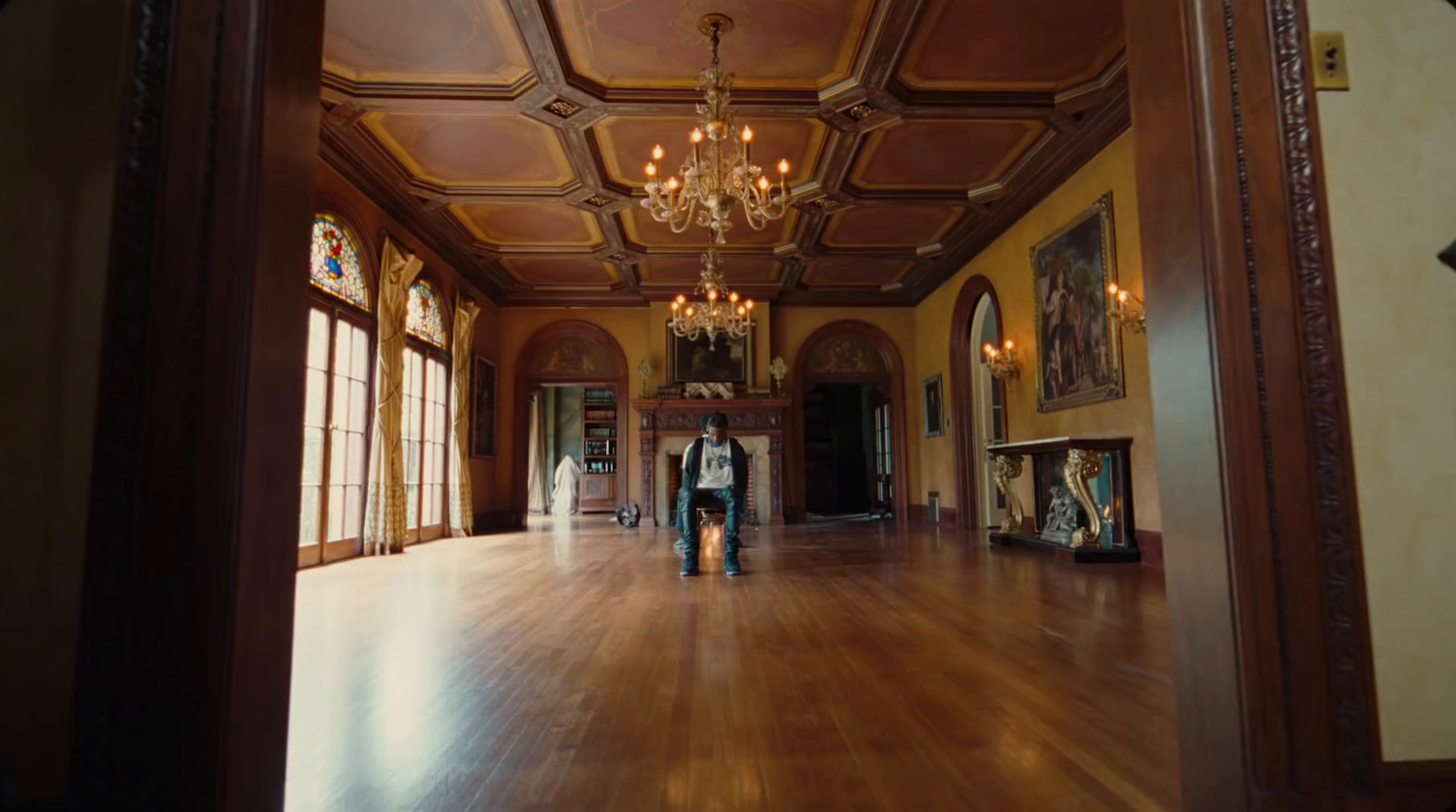 a person standing in a large room with a chandelier