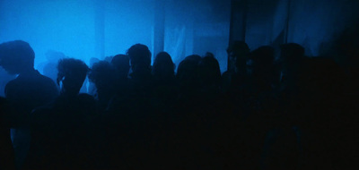 a group of people standing in a dark room