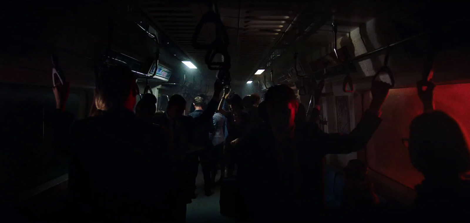 a group of people on a subway train at night