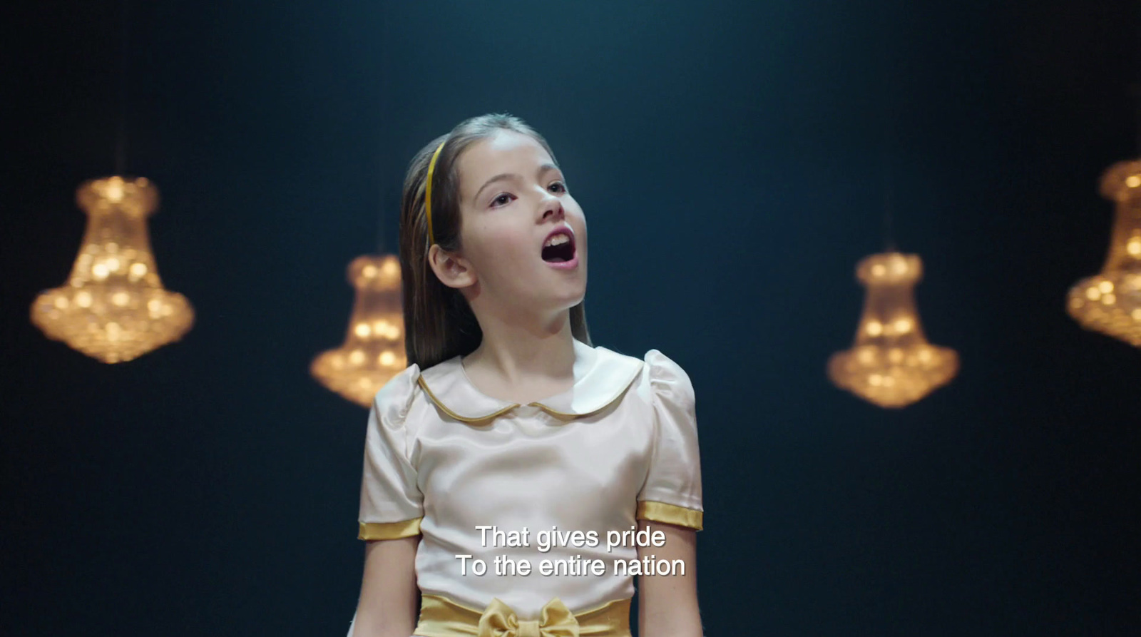 a young girl standing in front of a group of lights