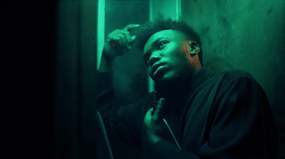 a man in a dark room brushing his hair