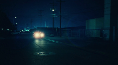 a car driving down a street at night