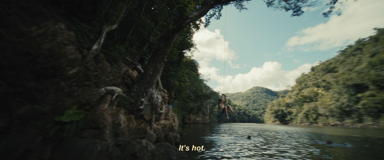 a body of water surrounded by trees and mountains