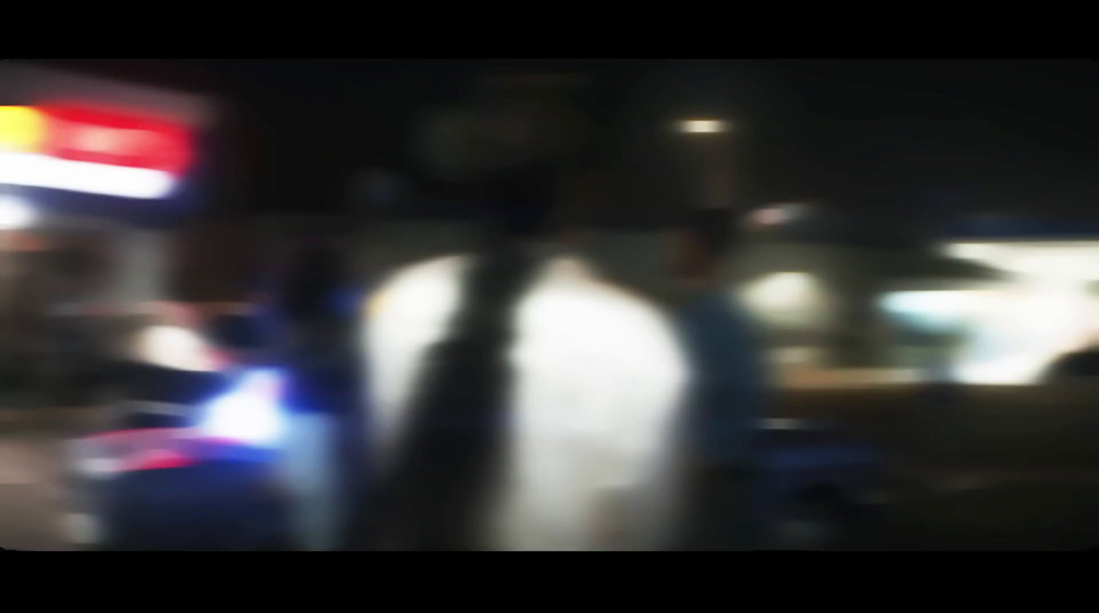 a blurry photo of a person walking down a street