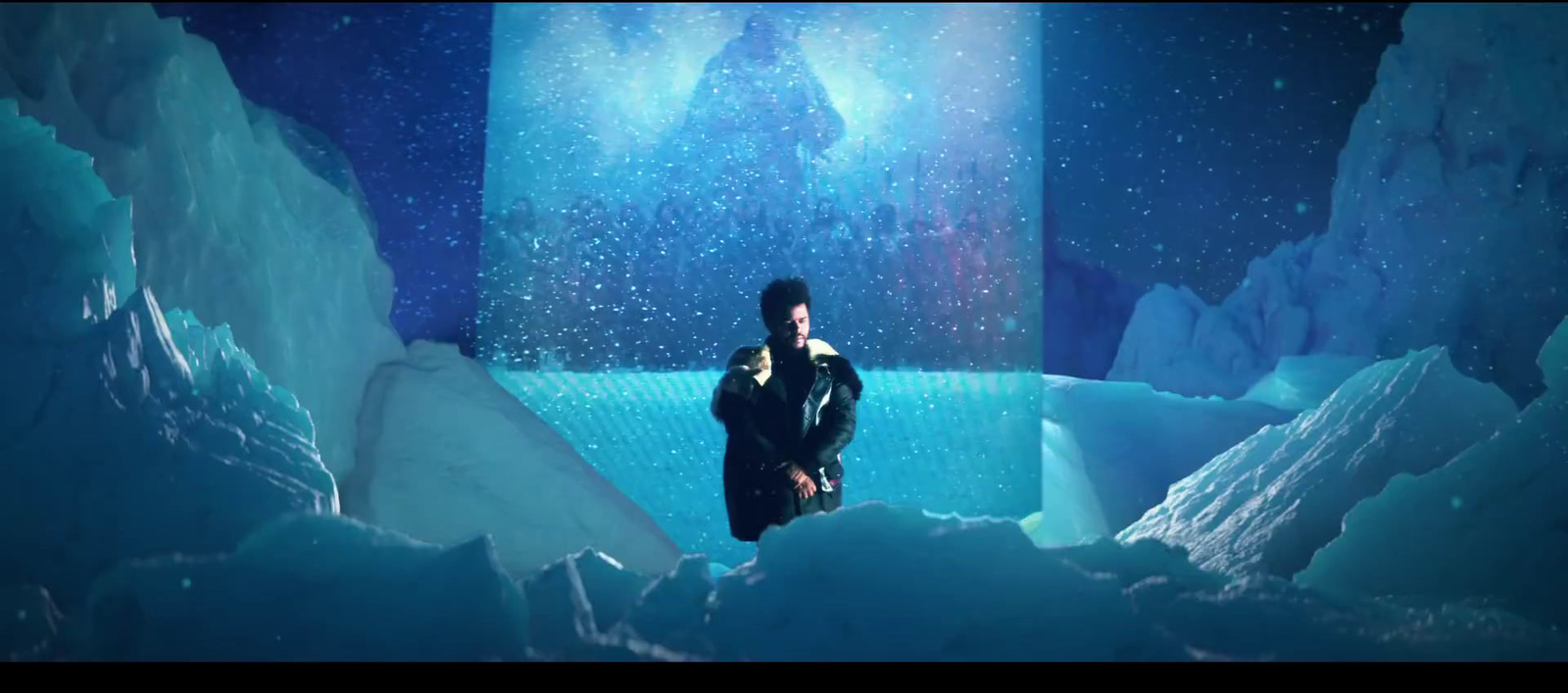 a woman standing in a tunnel of ice