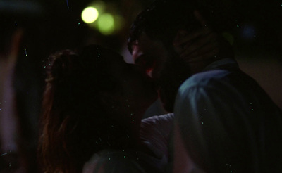 a man and a woman kissing in the dark