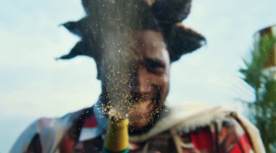 a man holding a wine bottle in front of his face
