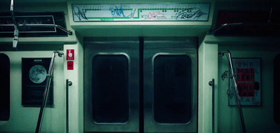 the doors of a subway car with graffiti on it