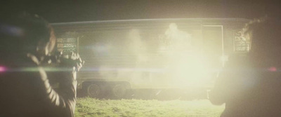 a group of people standing in front of a truck