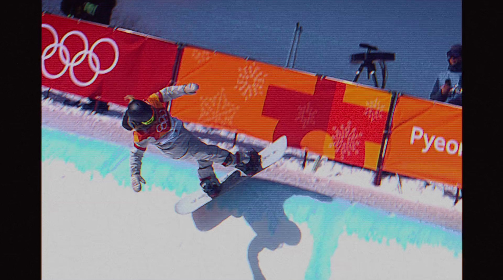 a man riding a snowboard down a snow covered slope