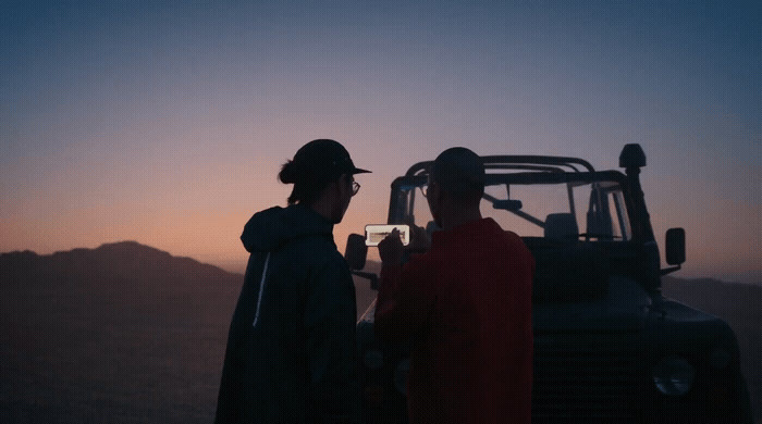 a couple of people standing next to a truck