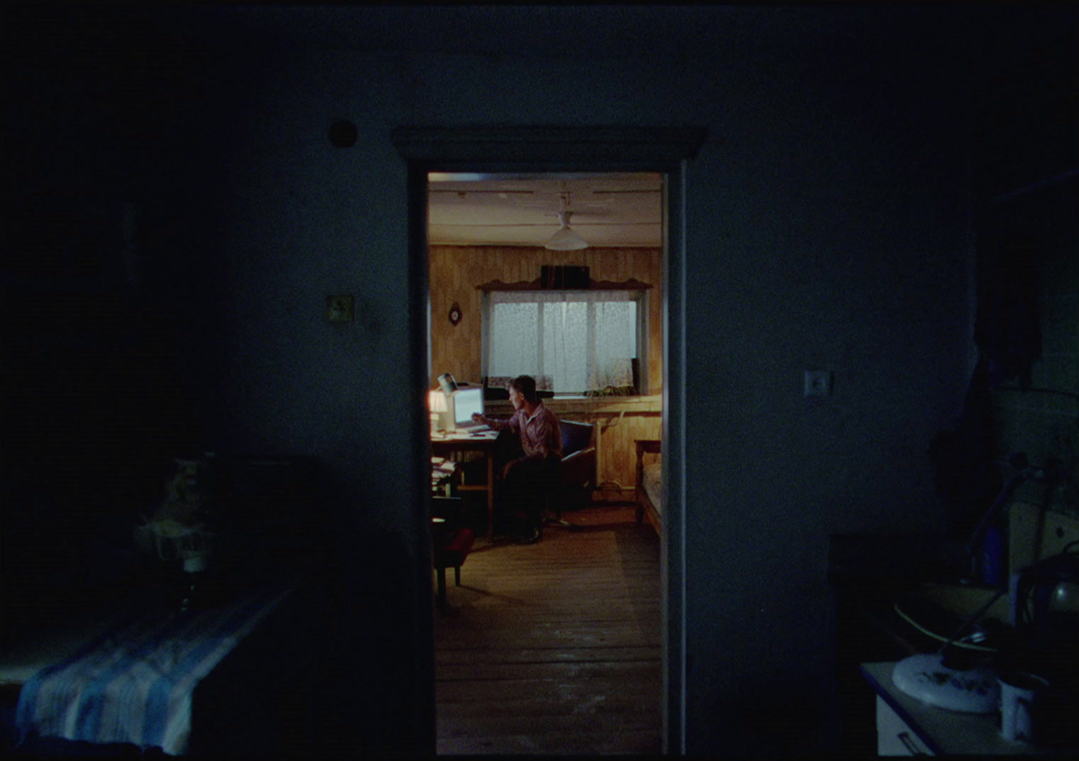 a person sitting at a table in a dark room