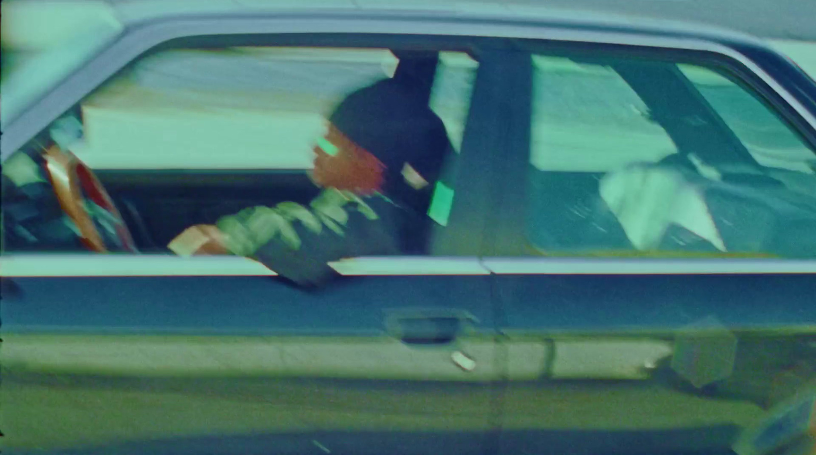 a blurry photo of a man driving a car