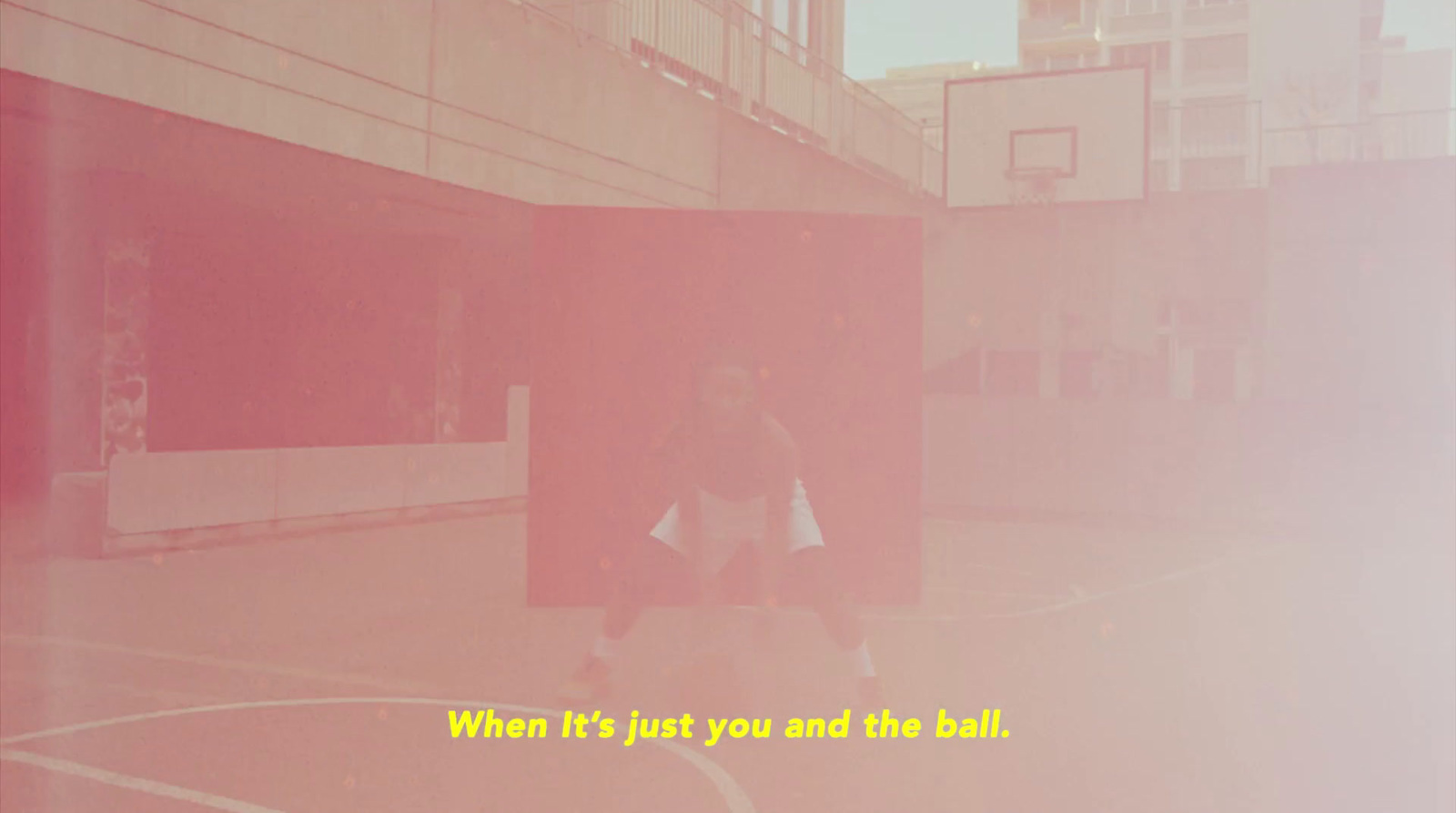 a man standing on a basketball court holding a basketball