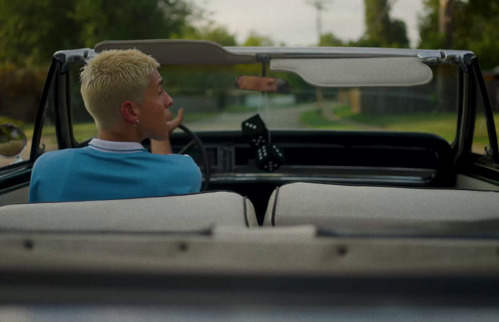 a man driving a car with a woman in the back seat