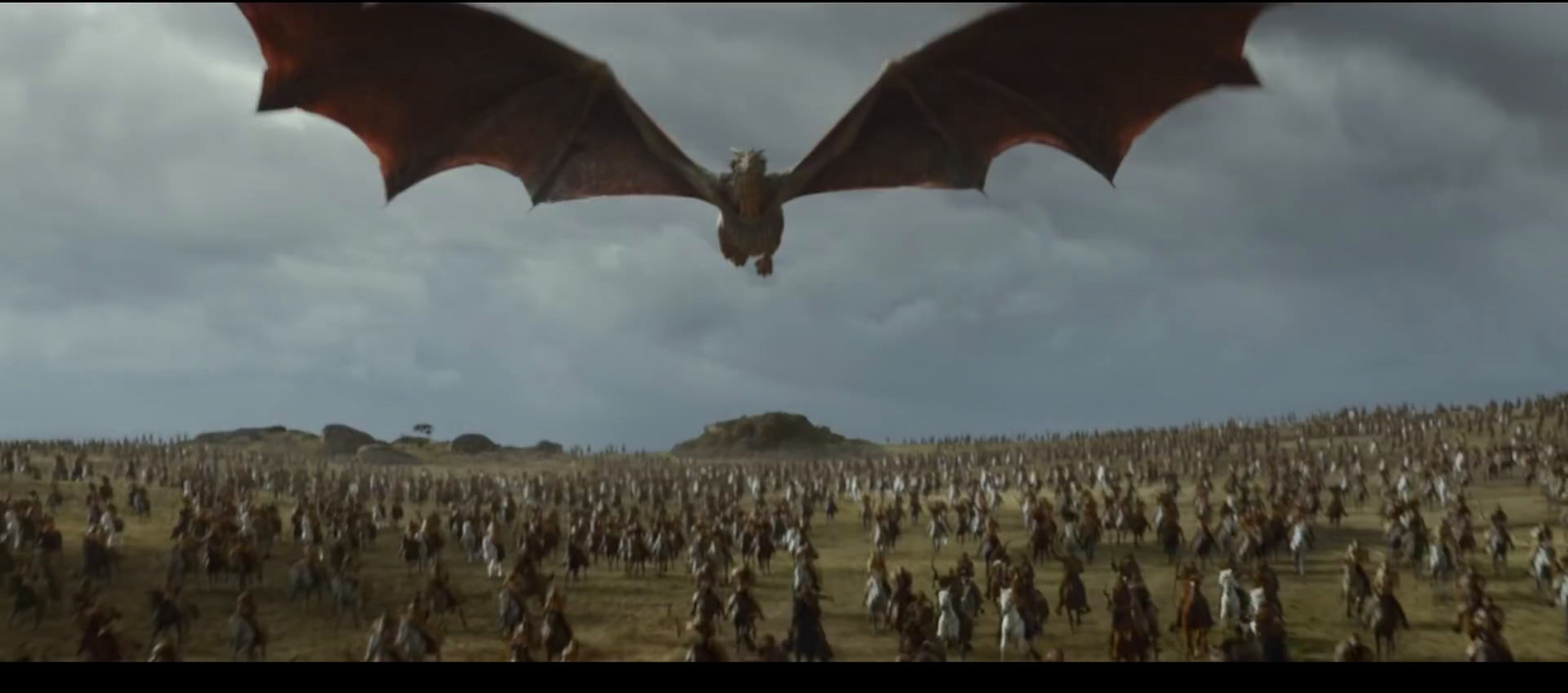 a dragon flying over a large group of people