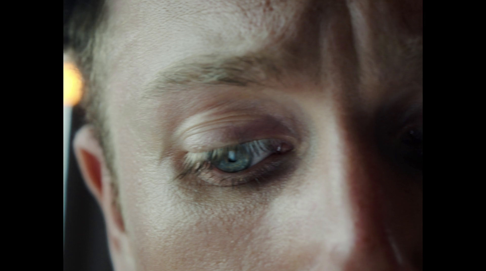 a close up of a person's eye with a blurry background