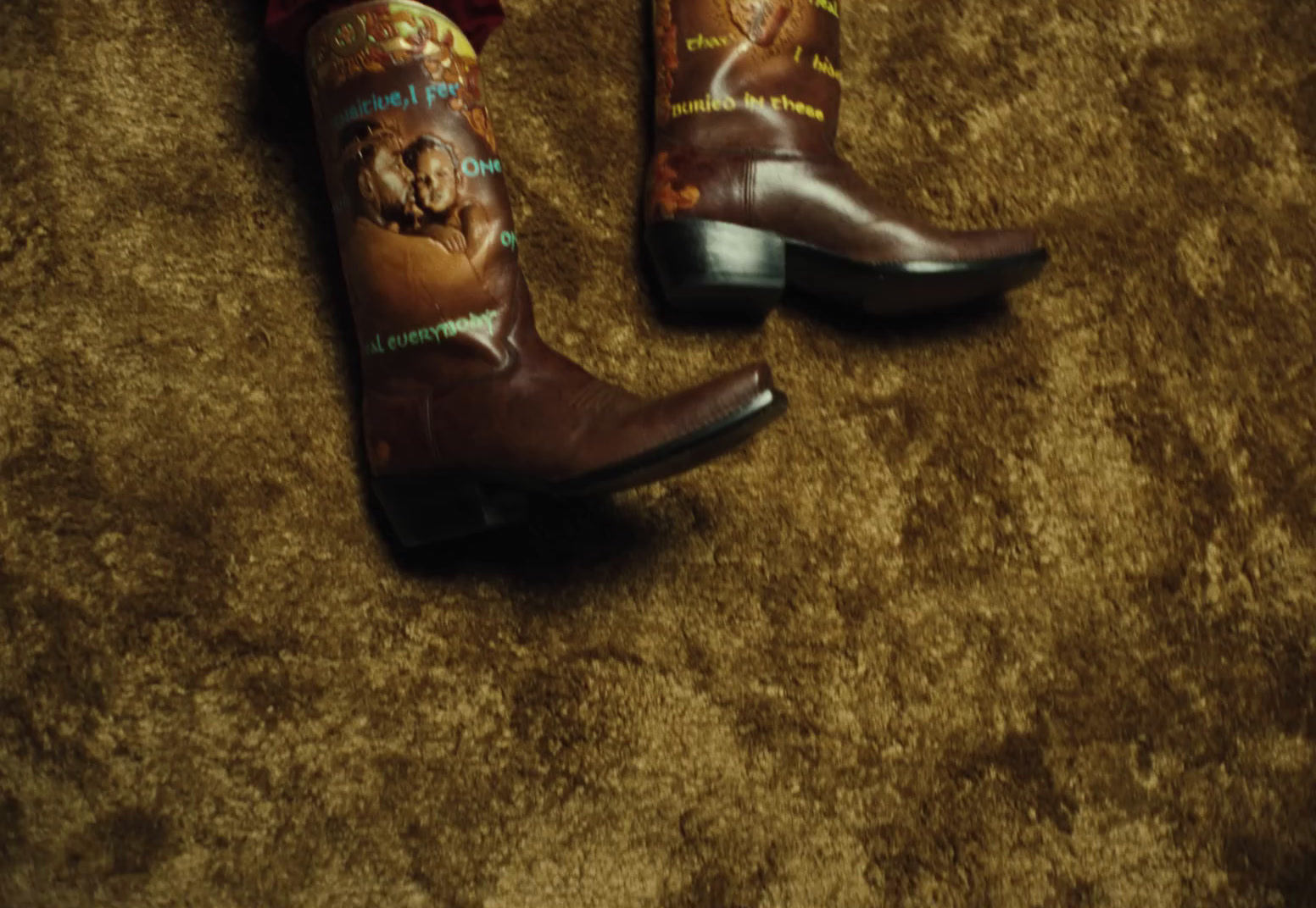 a pair of cowboy boots with dogs on them